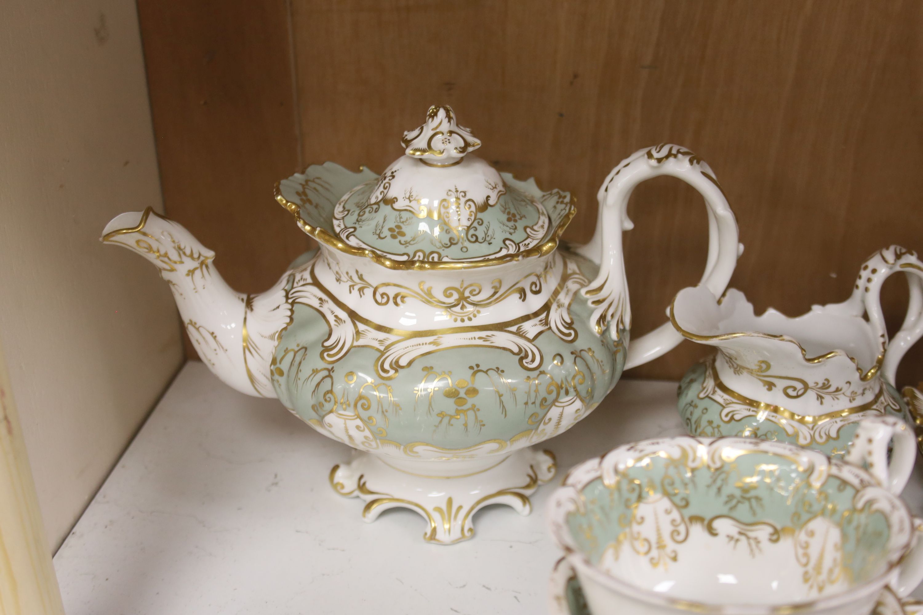 An English porcelain eau-de-nil gilt decorated tea service, c.1840